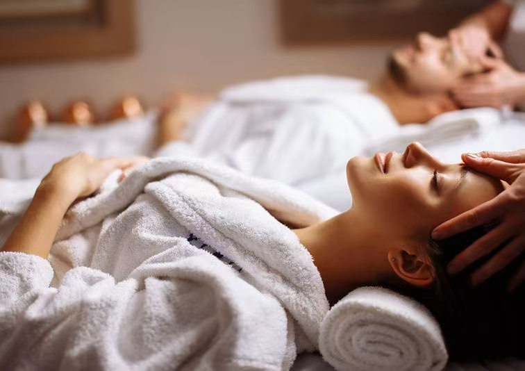 Two guests enjoying a couples massage