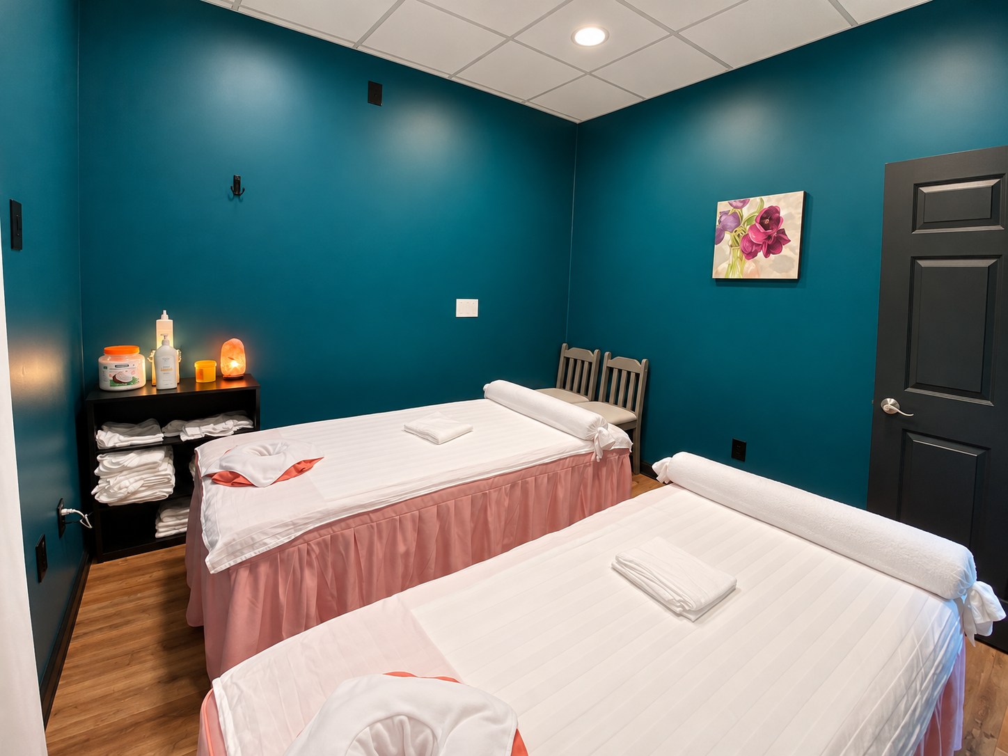 Sunflower’s actual teal-walled treatment room with two massage tables, photo retouched for lighting